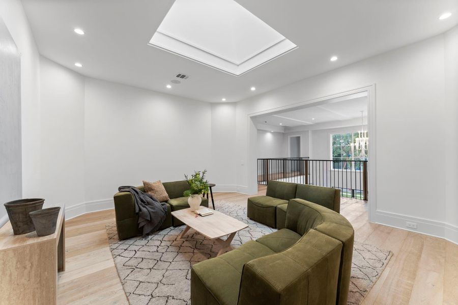 The second-floor game room includes a skylight, filling the space with natural light The second-floor game room includes a skylight, filling the space with natural light