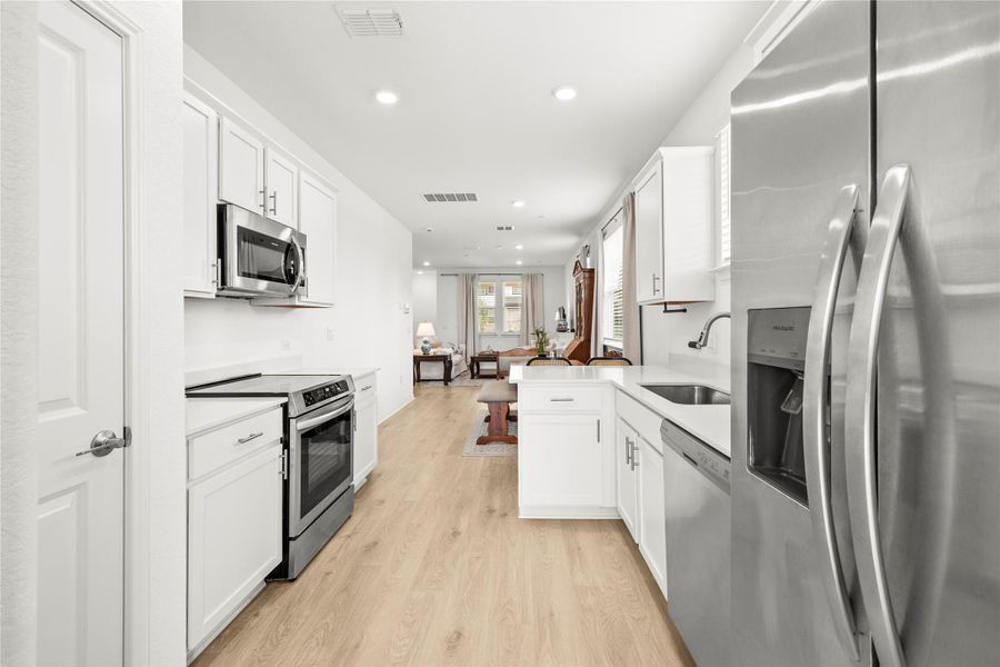 A streamlined kitchen flows into an airy living area, ideal for relaxed entertaining.