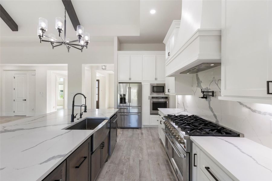 This kitchen has it all. Quartz countertops, pot-filler, an 8-burner gas range with two ovens and a built-in oven on the wall with a microwave above. This allows holiday meals to be prepped with ease. Soft-close doors and drawers with black hardware really make a statement in this kithen. The stainless steel refrigerator stays. This kitchen has it all. Quartz countertops, pot-filler, an 8-burner gas range with two ovens and a built-in oven on the wall with a microwave above. This allows holiday meals to be prepped with ease. Soft-close doors and drawers with black hardware really make a statement in this kithen. The stainless steel refrigerator stays.
