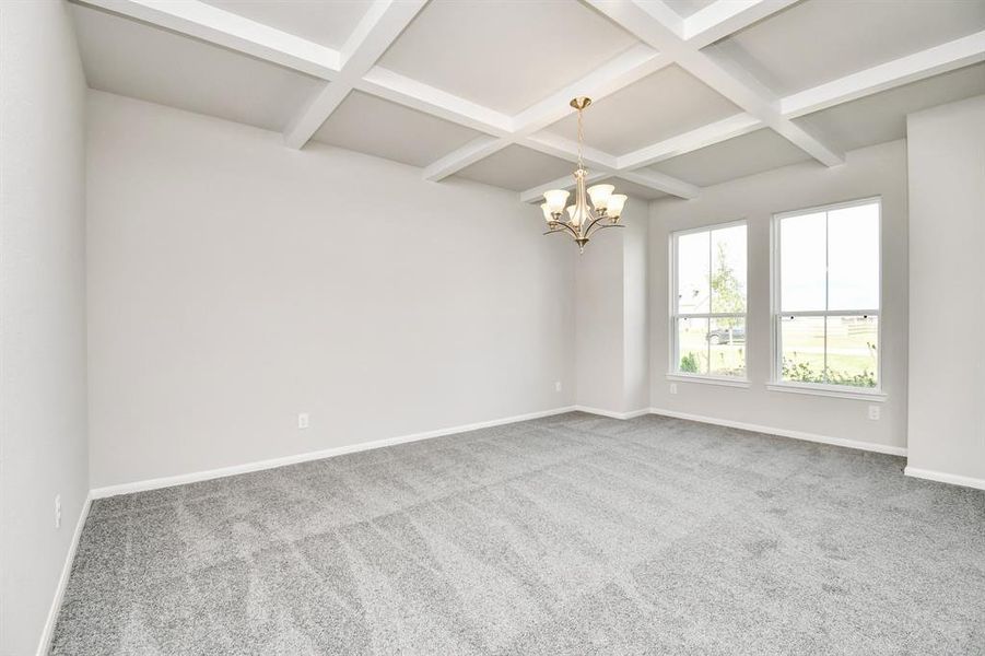 The dining room features plush carpet, high ceilings with beams, chandelier, and large windows.