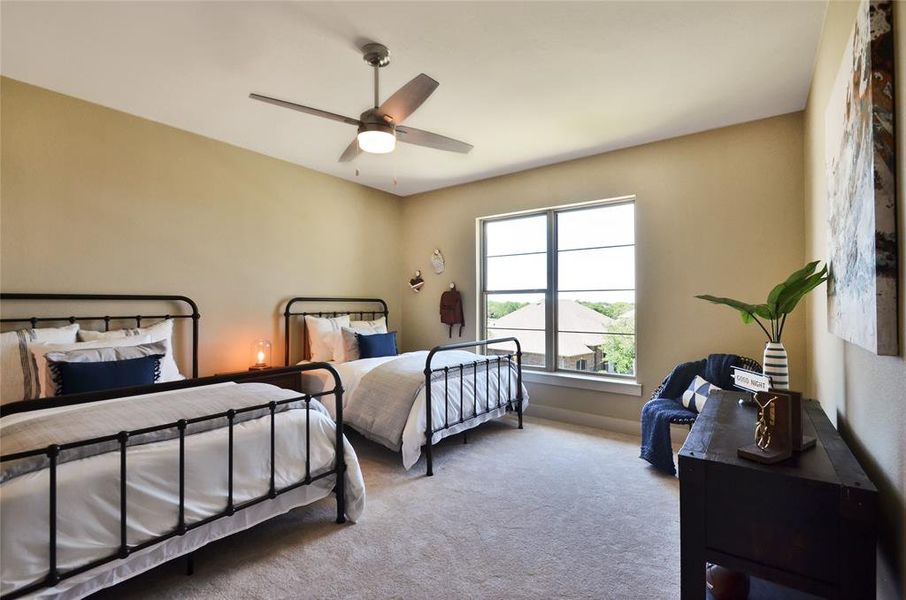 Bedroom with carpet flooring and a ceiling fan Bedroom with carpet flooring and a ceiling fan