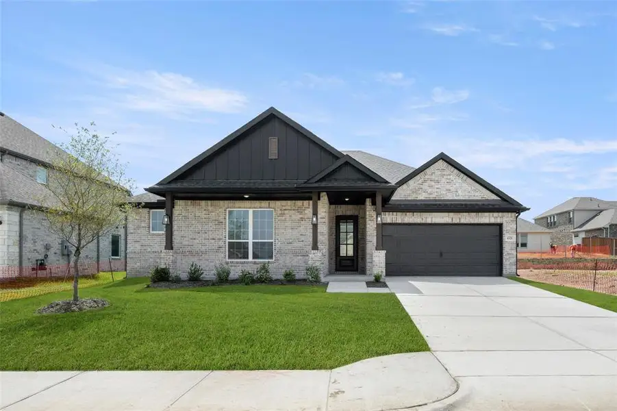 Front exterior of a new home in Westside Preserve - 60ft. lots, Midlothian, TX, highlighting curb appeal (Image 1).