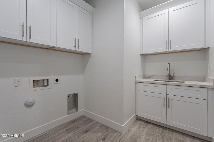 Laundry room with cabinets & sink