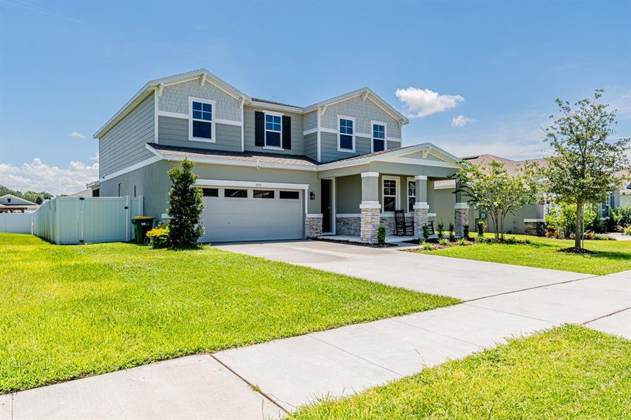 Front exterior of a new home in Seasons at Lakeside Forest, Tavares, FL, highlighting curb appeal (Image 24).