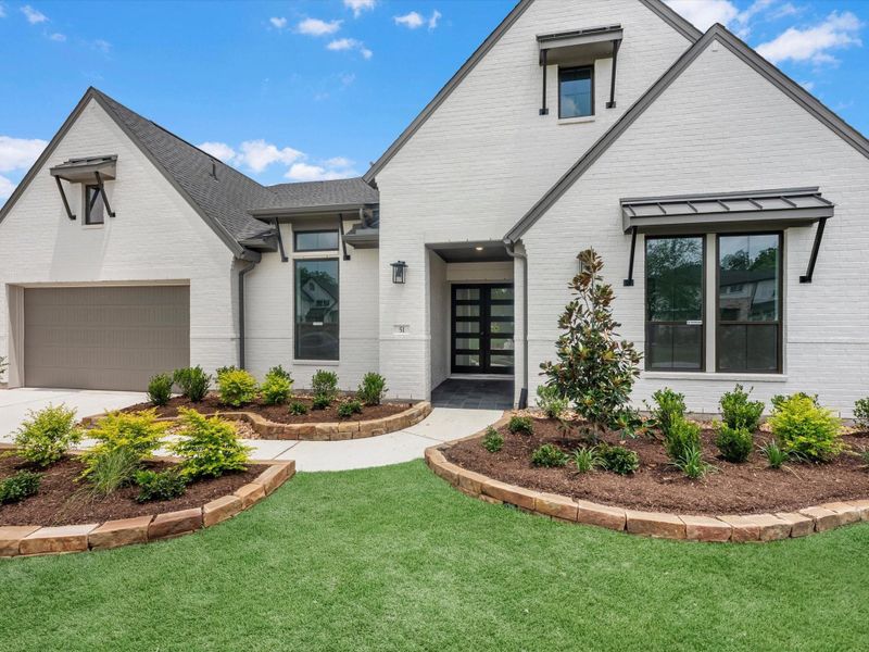 Front exterior of a new home in The Estates at James Lane, Fulshear, TX, highlighting curb appeal (Image 2).
