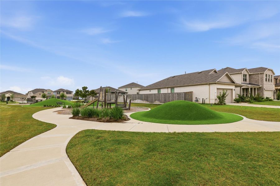 Family-friendly neighborhood with well-maintained sidewalks, a small playground, and modern homes.