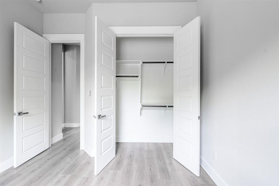 Streamlined storage solutions and clean-lined doors define this modern closet and hallway. Streamlined storage solutions and clean-lined doors define this modern closet and hallway.