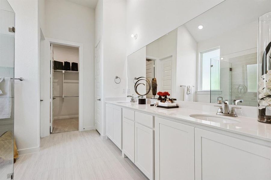 Bathroom featuring vanity and a shower with shower door