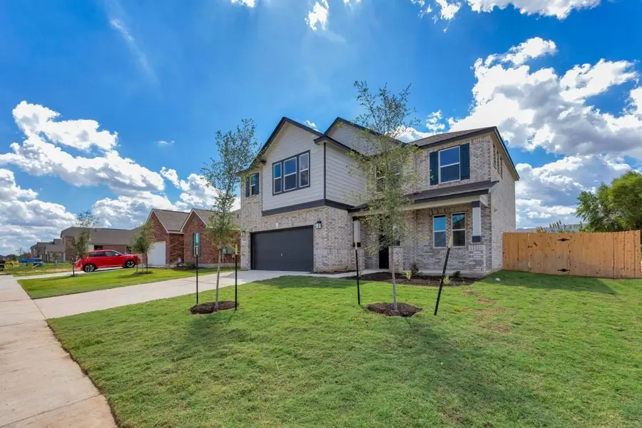 Front exterior of a new home in Mustang Valley, Manor, TX, highlighting curb appeal (Image 22).