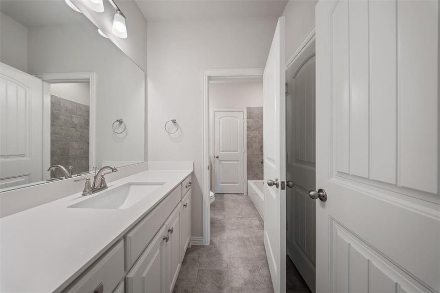 Full bath featuring vanity and tile patterned floors
