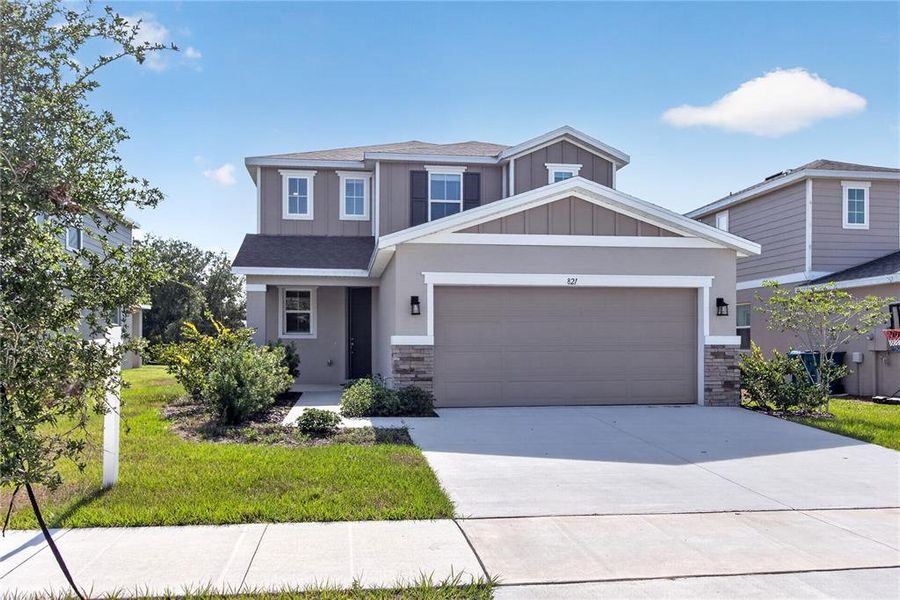 Front exterior of a new home in Seasons at Forest Creek, Haines City, FL, highlighting curb appeal (Image 33).