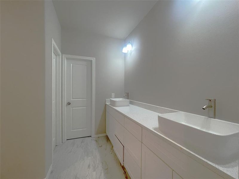 Bathroom with marble look tiles and double vanity