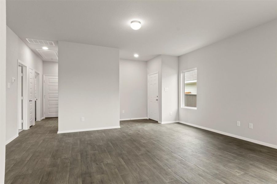 Empty room featuring recessed lighting and dark wood finished floors