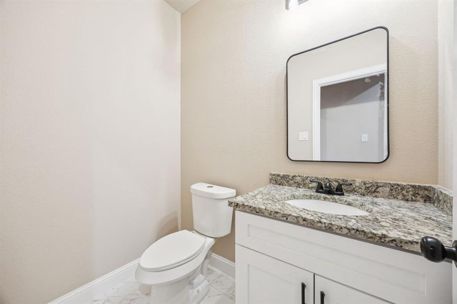 Bathroom with vanity and light marble finish floors Bathroom with vanity and light marble finish floors