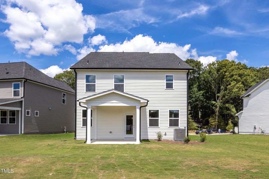 Front exterior of a new home in Woodland Crossing, Zebulon, NC, highlighting curb appeal (Image 2).