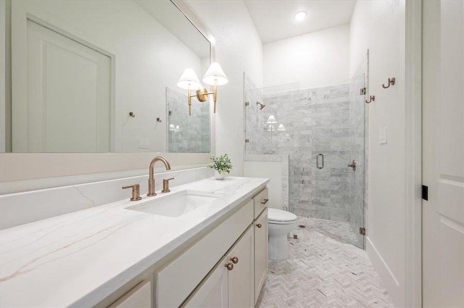 Bathroom with walk in shower, tile patterned floors, toilet, and vanity