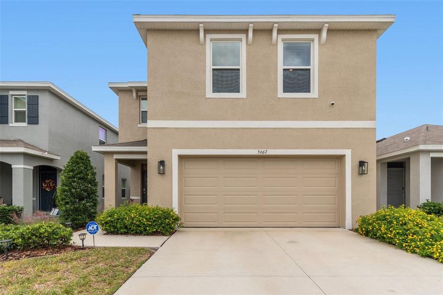Front exterior of a new home in Westgate at Avalon Park, Wesley Chapel, FL, highlighting curb appeal (Image 29).