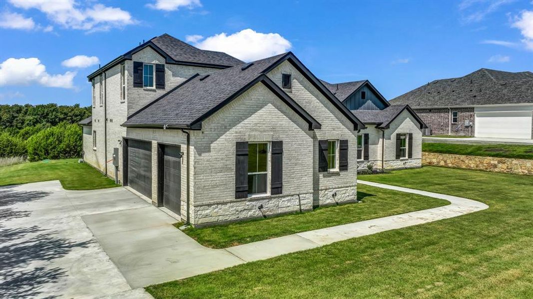 Front exterior of a new home in Woodland Lakes, Weatherford, TX, highlighting curb appeal (Image 24). Front exterior of a new home in Woodland Lakes, Weatherford, TX, highlighting curb appeal (Image 24).