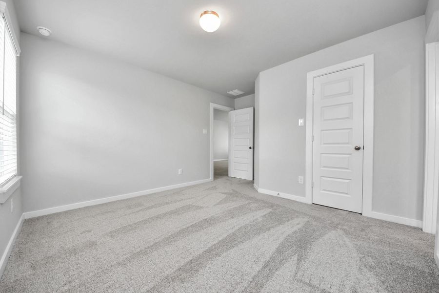 Generously sized secondary bedrooms featuring spacious closets, soft and inviting carpeting underfoot, large windows allowing plenty of natural light, and the added touch of privacy blinds for your personal retreat.