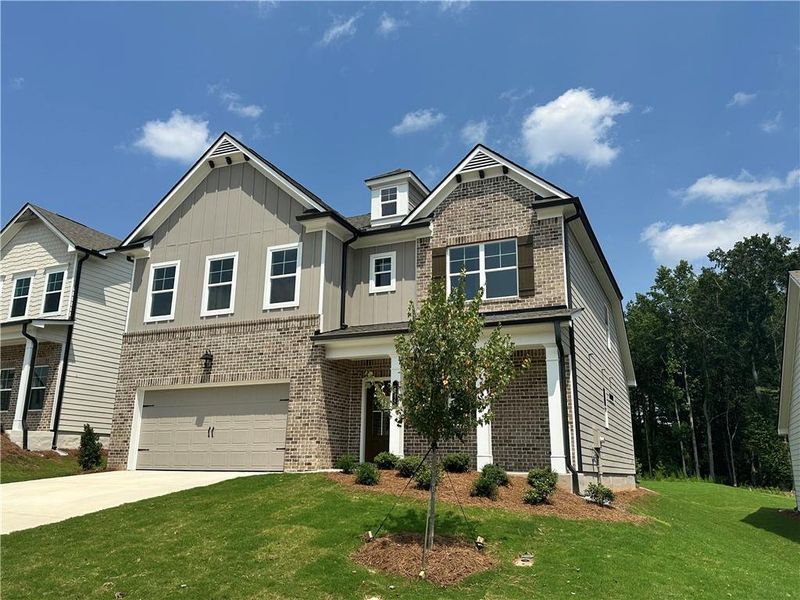 Front exterior of a new home in Summerlin, Winder, GA, highlighting curb appeal (Image 23). Front exterior of a new home in Summerlin, Winder, GA, highlighting curb appeal (Image 23).