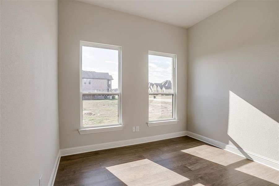 Unfurnished room featuring dark hardwood / wood-style flooring