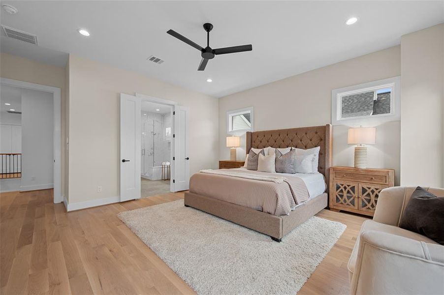 Spacious primary bedroom with white oak hardwood floors