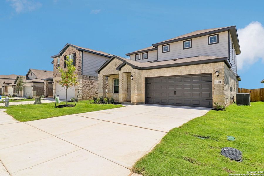 Front exterior of a new home in Sagebrooke - Premier Series, San Antonio, TX, highlighting curb appeal (Image 19). Front exterior of a new home in Sagebrooke - Premier Series, San Antonio, TX, highlighting curb appeal (Image 19).