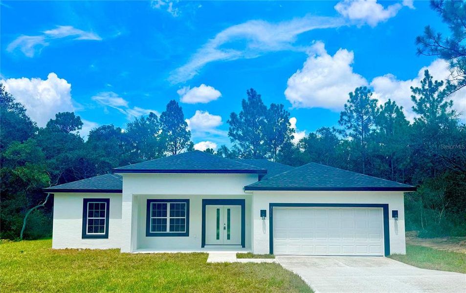 Front exterior of a new home in , Citrus Springs, FL, highlighting curb appeal (Image 1).