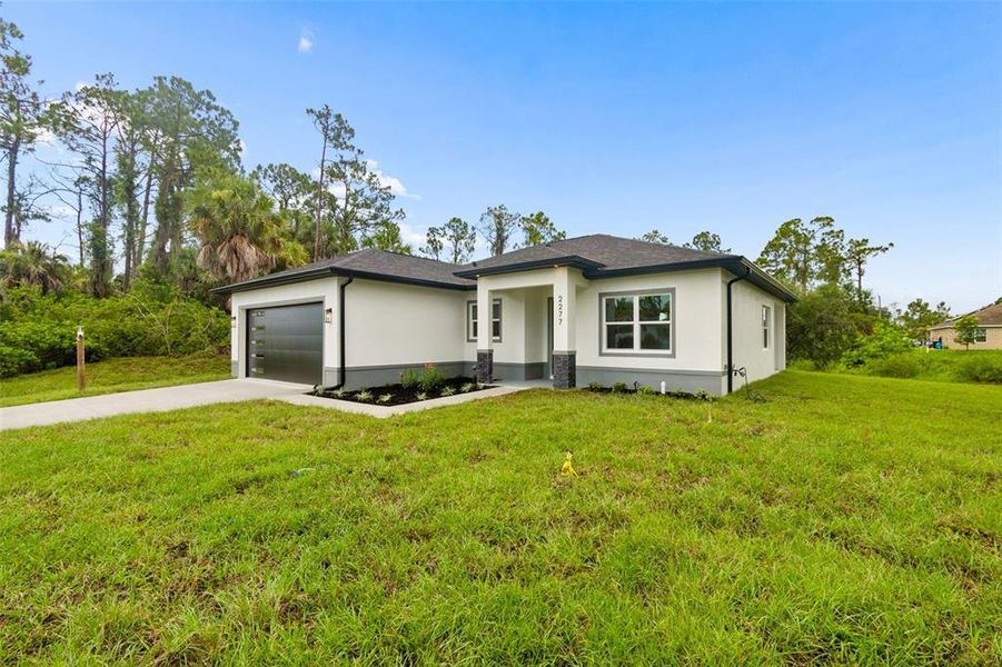 Front exterior of a new home in , North Port, FL, highlighting curb appeal (Image 34). Front exterior of a new home in , North Port, FL, highlighting curb appeal (Image 34).