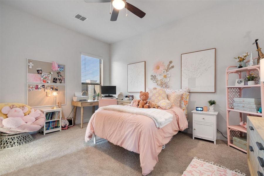 A well-lit bedroom provides a comfortable retreat with plush carpeting underfoot. A well-lit bedroom provides a comfortable retreat with plush carpeting underfoot.