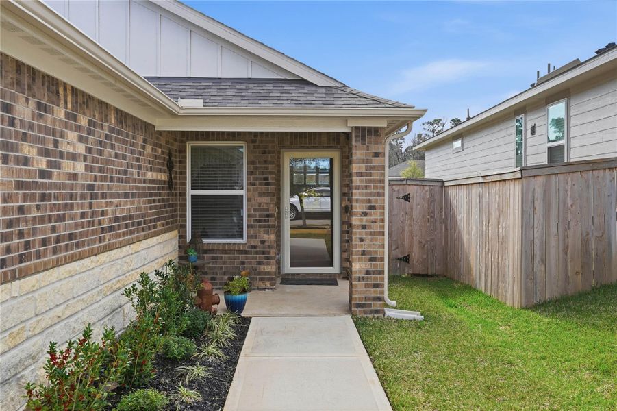 The front of the home makes a warm first impression with beautiful landscaping and a charming front porch.