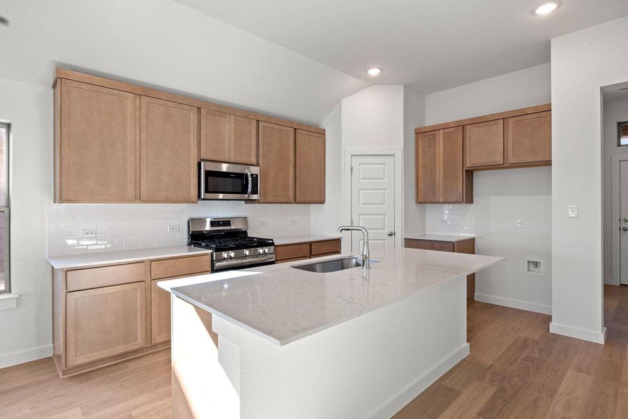 Culinary creations come to life in this kitchen, featuring a central island and contemporary finishes.