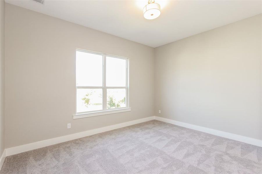 Unfurnished room with light carpet