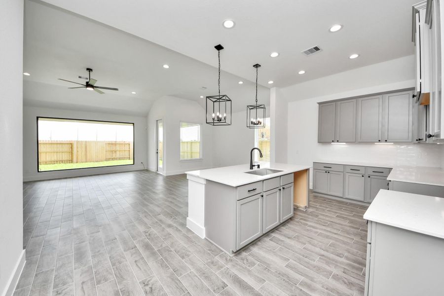 This kitchen is by far any chef’s dream! This spacious kitchen features high ceilings, light stained wood cabinets, granite countertop, SS appliances, modern tile backsplash, recessed lighting, extended counter space, granite kitchen island, and space for breakfast bar, and a walk-in pantry all overlooking your huge family room. This kitchen is by far any chef’s dream! This spacious kitchen features high ceilings, light stained wood cabinets, granite countertop, SS appliances, modern tile backsplash, recessed lighting, extended counter space, granite kitchen island, and space for breakfast bar, and a walk-in pantry all overlooking your huge family room.