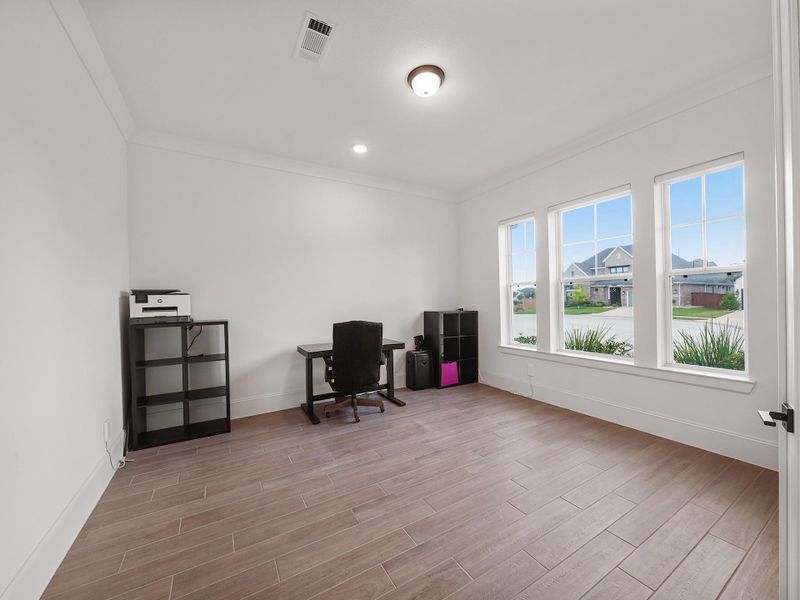 Perfect for remote work, studies, or creative projects, the dedicated home office offers privacy without feeling closed off. Oversized windows let in plenty of natural light, while its placement near the front of the home makes it versatile for any use.