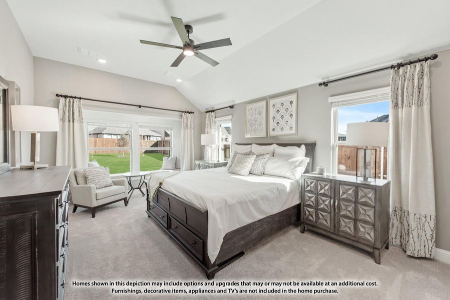 Master bedroom with vaulted ceiling, ceiling fan, dark wood bed frame, and carpet flooring with large windows Master bedroom with vaulted ceiling, ceiling fan, dark wood bed frame, and carpet flooring with large windows