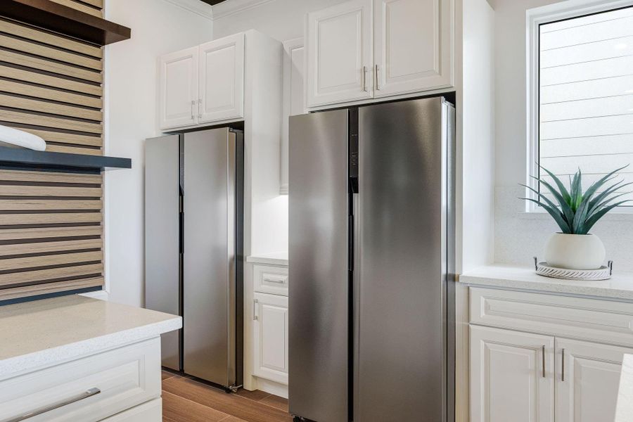Double refrigerators with access to the pantry.