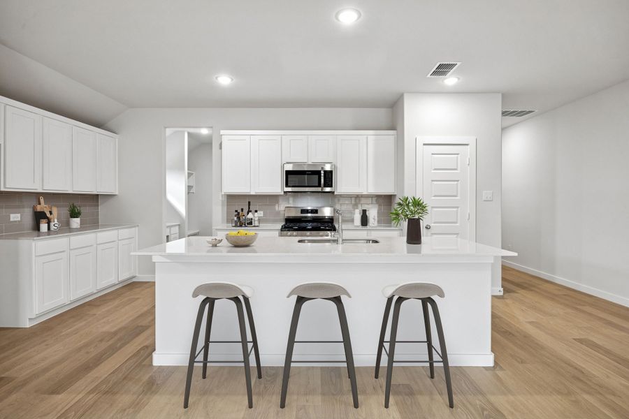 Kitchen in the Heisman home plan by Trophy Signature Homes – REPRESENTATIVE PHOTO