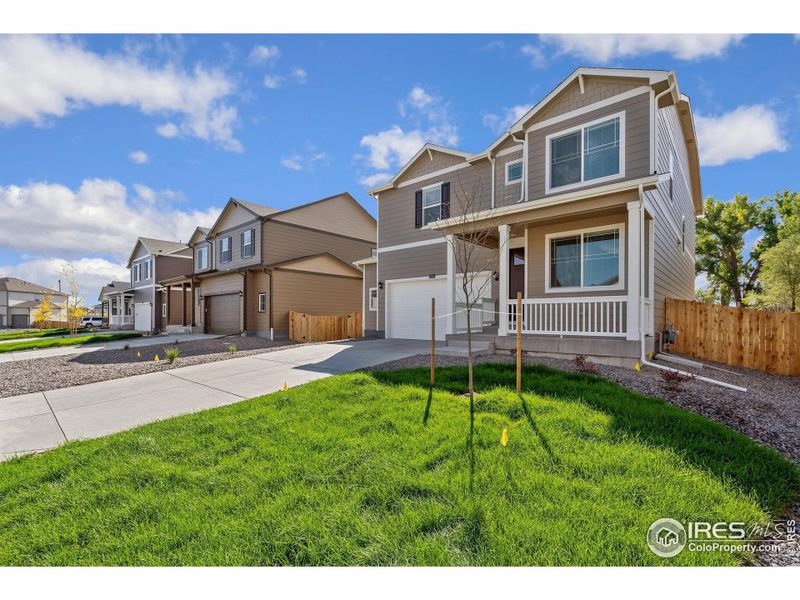Front exterior of a new home in Brighton Crossing, Brighton, CO, highlighting curb appeal (Image 17).