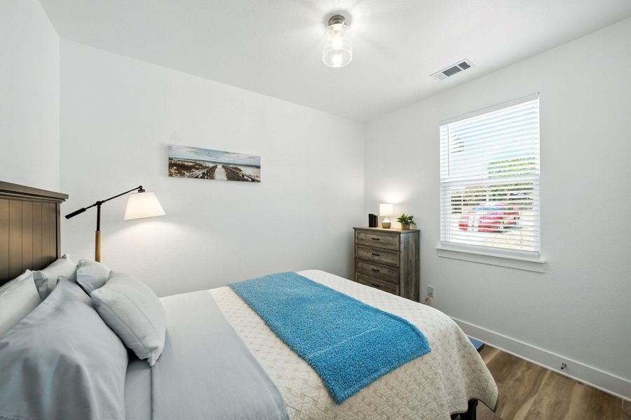 Bedroom with vinyl plank floors, high ceiling and lots of natural light Bedroom with vinyl plank floors, high ceiling and lots of natural light