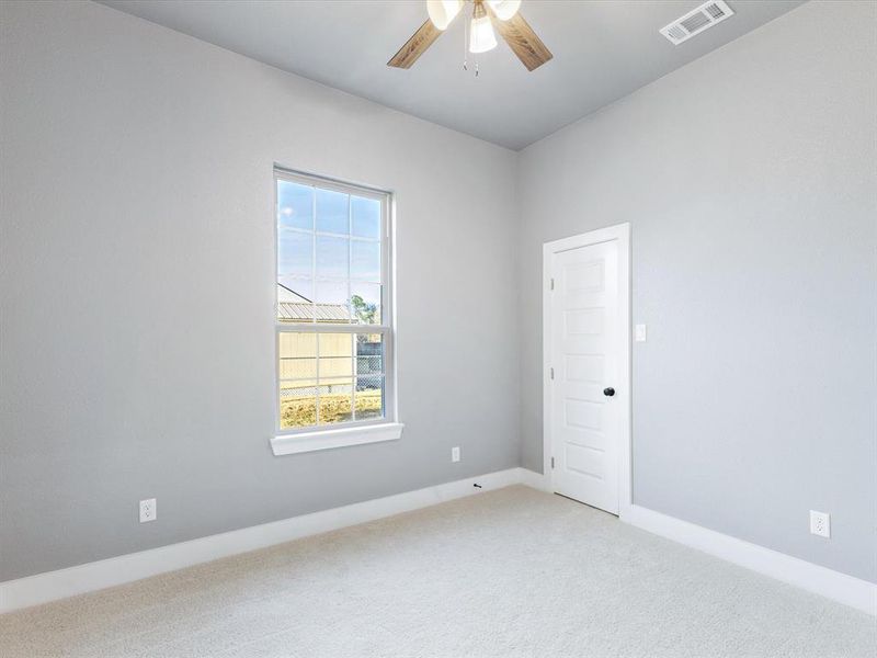 Carpeted spare room featuring a ceiling fan and baseboards Carpeted spare room featuring a ceiling fan and baseboards