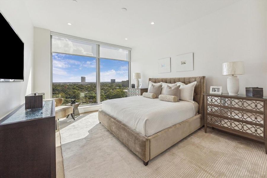 Staged with a king-sized bed and side tables, it is easy to imagine waking up in the primary bedroom with this beautiful view in the morning.