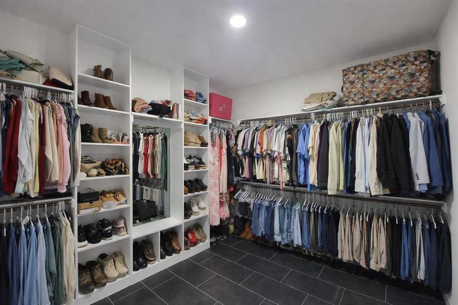 Walk in closet featuring dark tile patterned floors Walk in closet featuring dark tile patterned floors