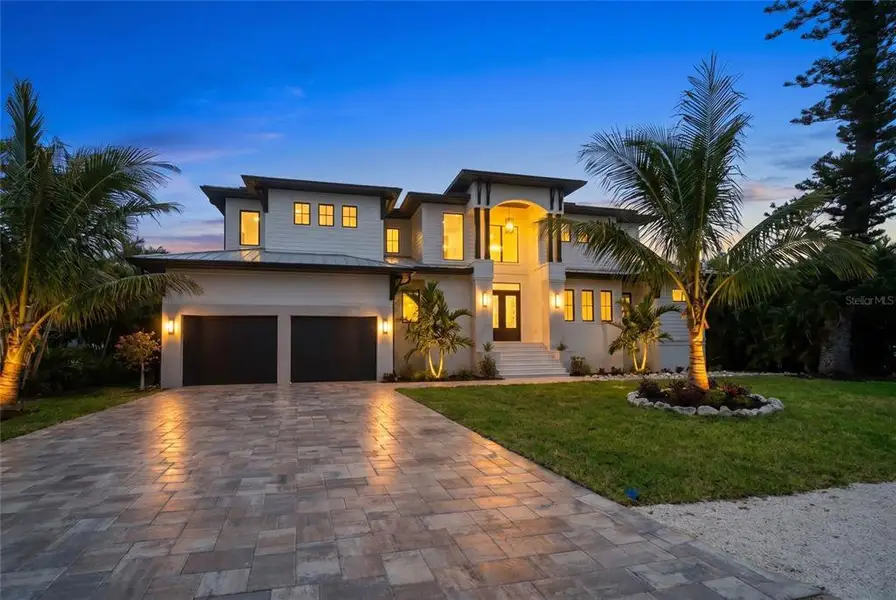Front exterior of a new home in , Longboat Key, FL, highlighting curb appeal (Image 1). Front exterior of a new home in , Longboat Key, FL, highlighting curb appeal (Image 1).
