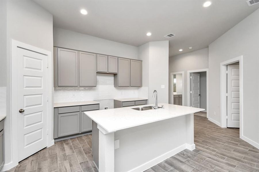 This haven Boasts high ceilings, recessed lighting, stained wood cabinets, granite countertops, stainless steel appliances (to be installed), a modern tile backsplash. Sample photo of similar plan. Actual colors and selections may vary.