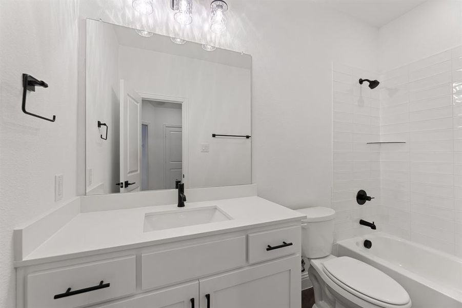 Bathroom featuring bathing tub / shower combination and vanity Bathroom featuring bathing tub / shower combination and vanity