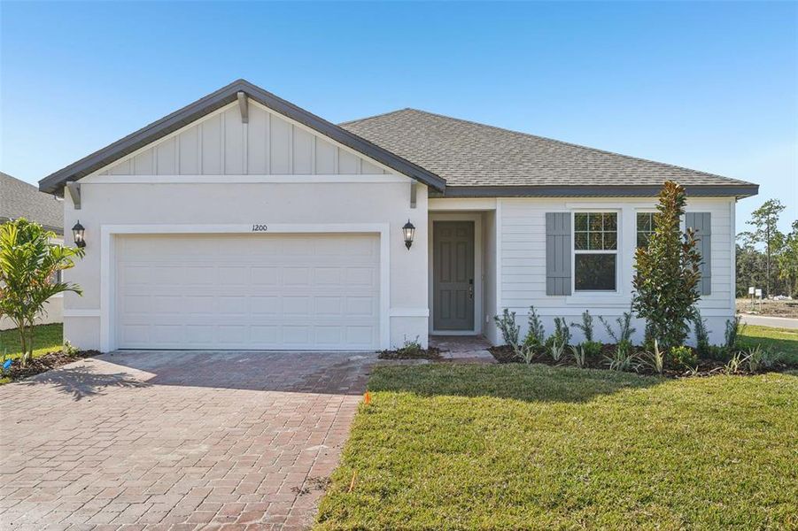 Front exterior of a new home in Legends Preserve - Signature Series, Daytona Beach, FL, highlighting curb appeal (Image 2). Front exterior of a new home in Legends Preserve - Signature Series, Daytona Beach, FL, highlighting curb appeal (Image 2).