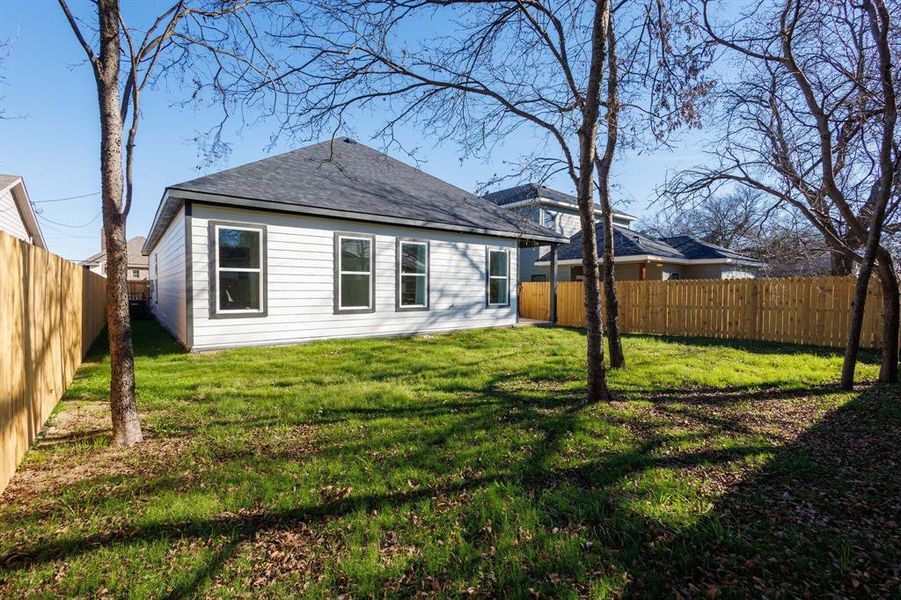 Back of house featuring a lawn