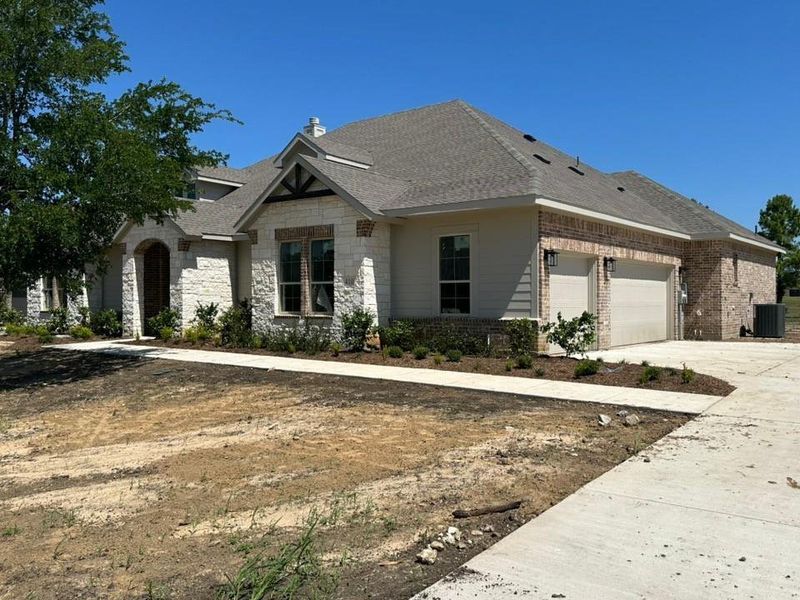 Front exterior of a new home in Fannin Ranch, Leonard, TX, highlighting curb appeal (Image 2). Front exterior of a new home in Fannin Ranch, Leonard, TX, highlighting curb appeal (Image 2).