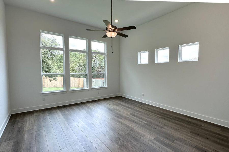 Tall windows and high ceilings define this bright and inviting living space.